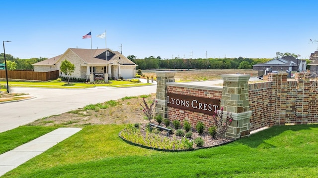 community sign featuring a lawn