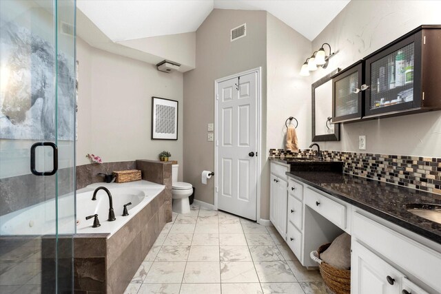 full bath with marble finish floor, a garden tub, visible vents, toilet, and vaulted ceiling