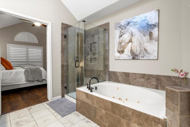 bathroom featuring a whirlpool tub, vaulted ceiling, a shower stall, and ensuite bath