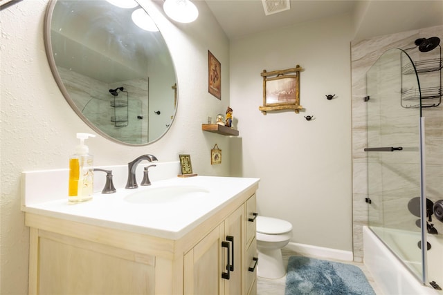 bathroom with toilet, shower / bath combination with glass door, visible vents, vanity, and baseboards