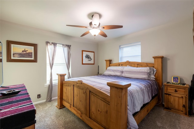 carpeted bedroom with ceiling fan and baseboards