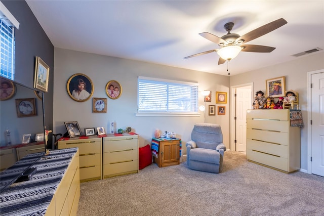 interior space featuring light carpet, visible vents, and a ceiling fan