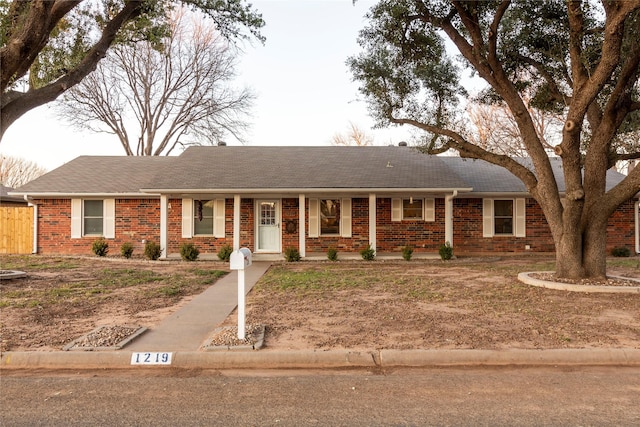 ranch-style house with brick siding and roof with shingles