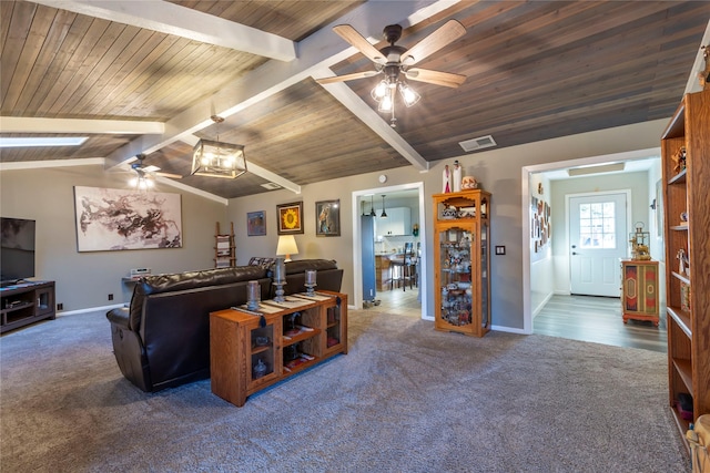 living room with vaulted ceiling with beams, ceiling fan, visible vents, and dark colored carpet