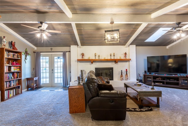 living room featuring carpet, french doors, a ceiling fan, a brick fireplace, and wooden ceiling