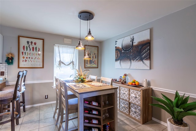 dining space with light tile patterned floors and baseboards