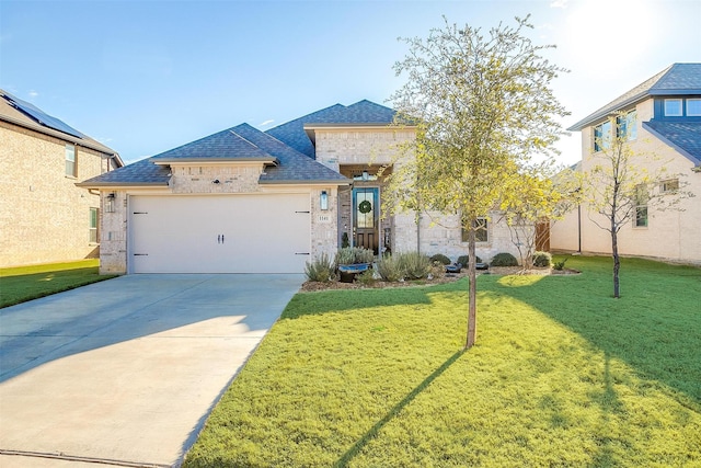 view of front of house featuring driveway, a front lawn, and an attached garage