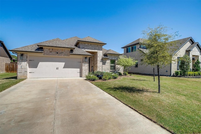 view of front of house featuring roof with shingles, a front lawn, brick siding, a garage, and concrete driveway