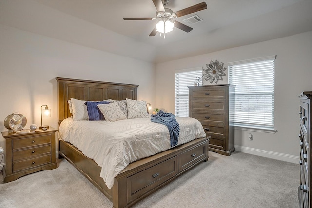 bedroom with baseboards, multiple windows, light colored carpet, and visible vents