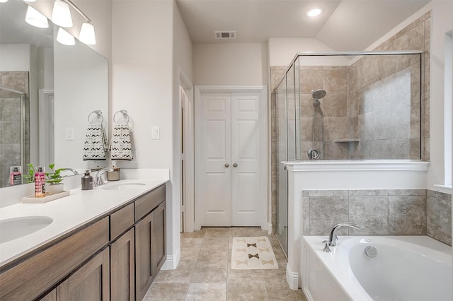 full bath with visible vents, a sink, a bath, and a shower stall