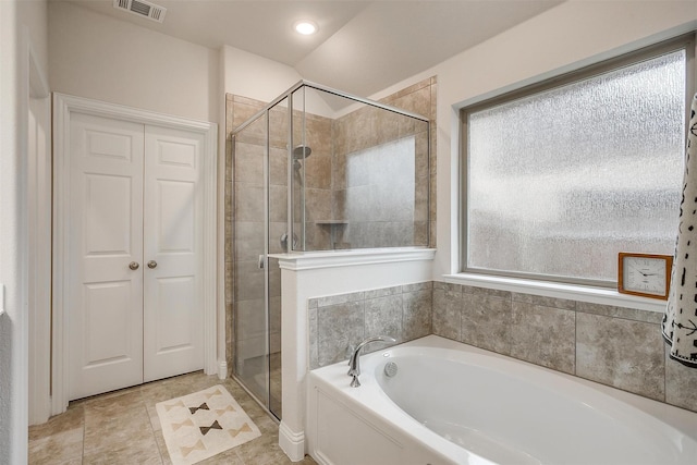 bathroom with a shower stall, a bath, and visible vents