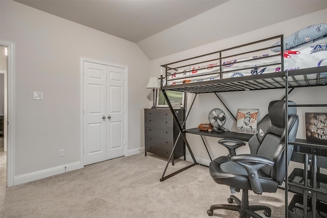 carpeted bedroom featuring baseboards and vaulted ceiling