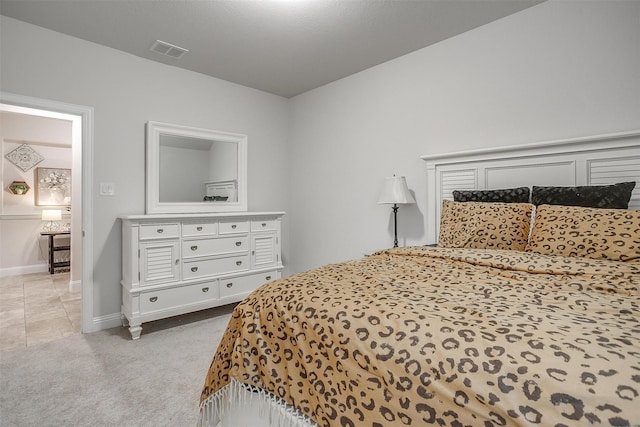 bedroom featuring baseboards, carpet flooring, and visible vents