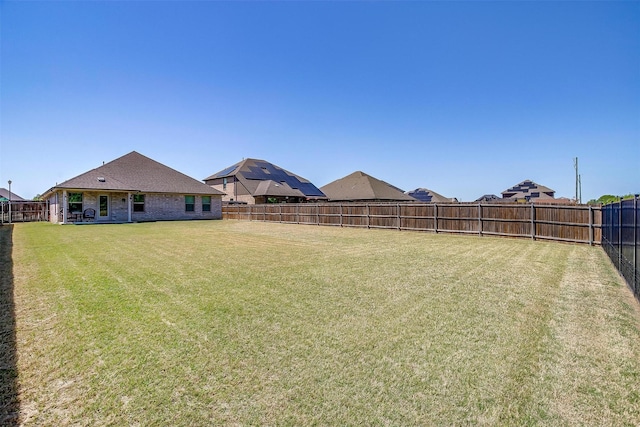 view of yard with a fenced backyard