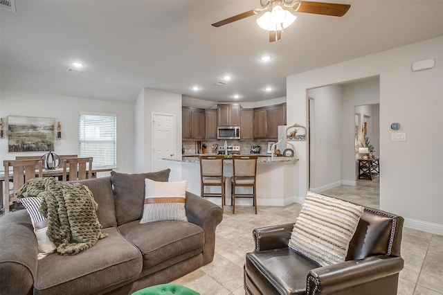 living room featuring recessed lighting, ceiling fan, and light tile patterned floors