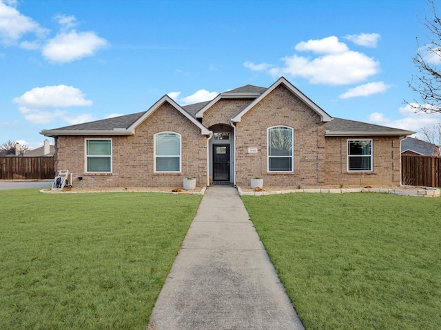 single story home with roof with shingles, brick siding, a front lawn, and fence