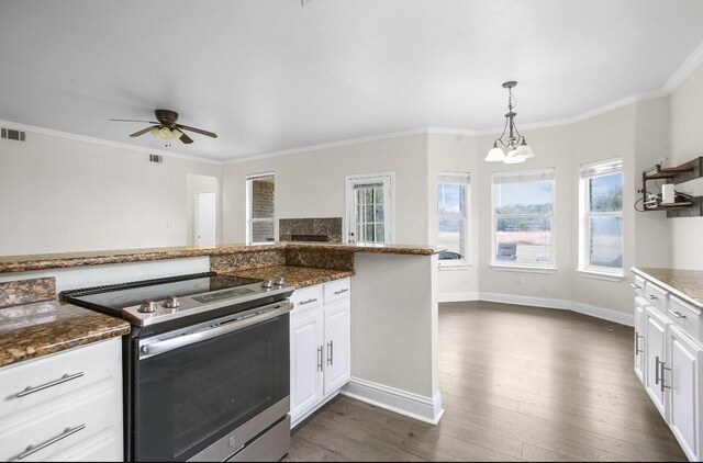 kitchen featuring dark stone counters, dark wood-style floors, white cabinetry, stainless steel electric range oven, and decorative light fixtures