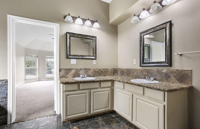 bathroom with a sink and double vanity