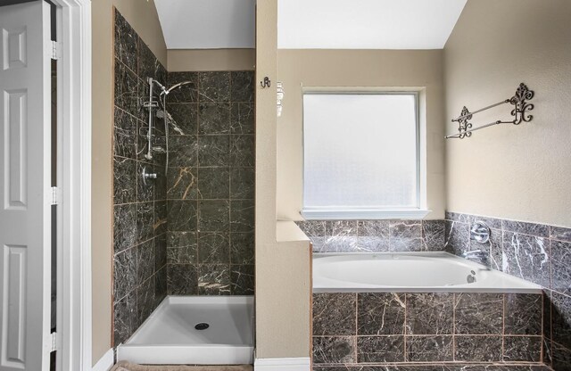 full bath featuring a garden tub and a shower stall