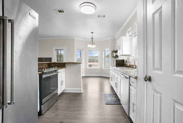 kitchen featuring stone counters, visible vents, appliances with stainless steel finishes, white cabinets, and a sink