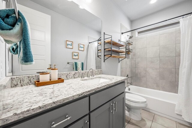 bathroom featuring recessed lighting, toilet, shower / bath combo, vanity, and tile patterned flooring