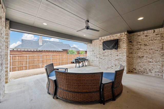 view of patio with a ceiling fan, outdoor dining area, fence, and area for grilling