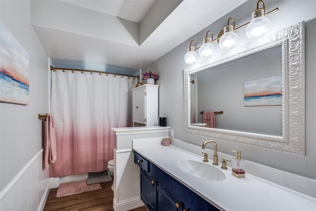 full bathroom with toilet, a shower with curtain, wood finished floors, and vanity