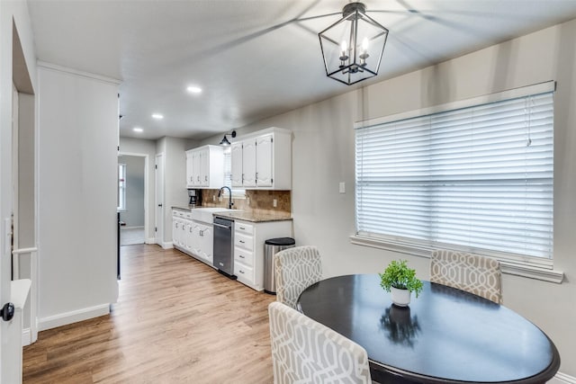 dining room featuring baseboards, recessed lighting, light wood-style flooring, and a notable chandelier