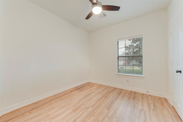 spare room featuring visible vents, ceiling fan, light wood-style flooring, and baseboards