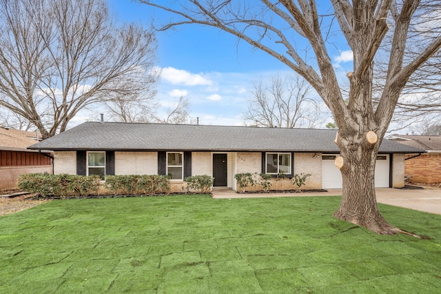 ranch-style home with a front yard, concrete driveway, brick siding, and an attached garage