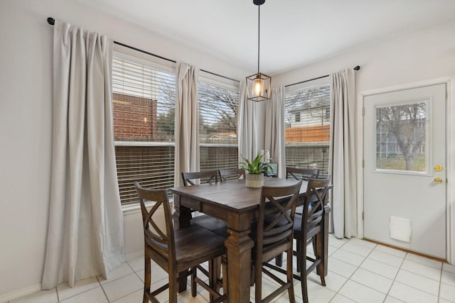 dining room with light tile patterned floors and baseboards