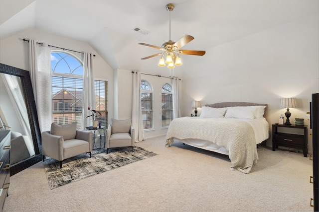 bedroom featuring ceiling fan, visible vents, vaulted ceiling, and carpet flooring