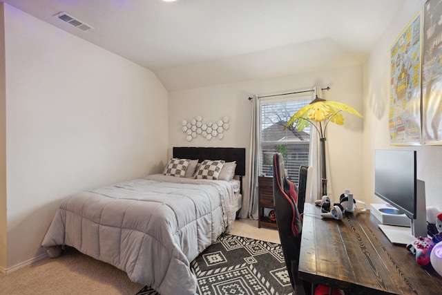 carpeted bedroom featuring visible vents and vaulted ceiling