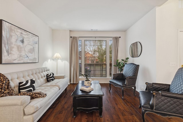 living area featuring dark wood-style floors, visible vents, and baseboards