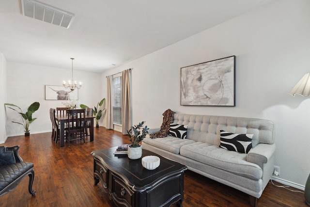 living area featuring dark wood-style floors, baseboards, visible vents, and a notable chandelier