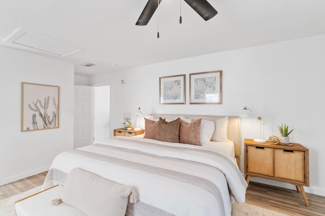 bedroom featuring baseboards, visible vents, and light wood-style floors