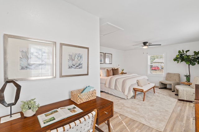 bedroom with light wood-style floors and a ceiling fan