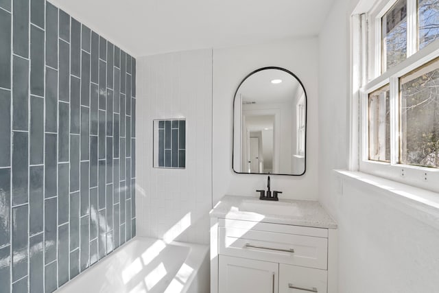 full bathroom featuring  shower combination, a wealth of natural light, and vanity