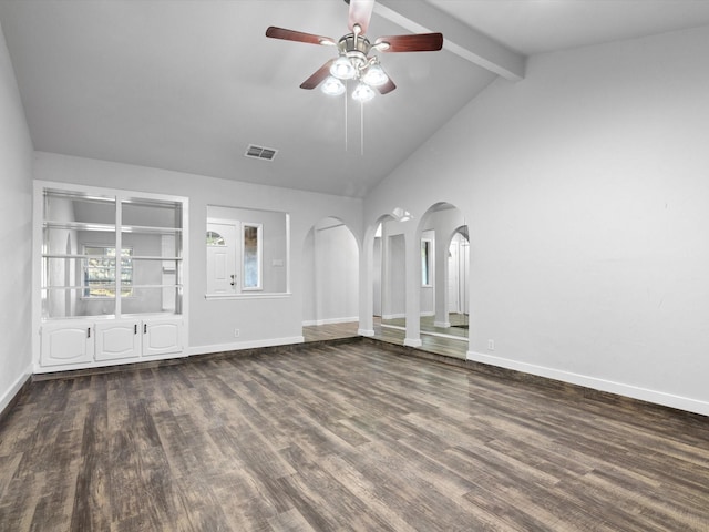 empty room with vaulted ceiling with beams, baseboards, arched walkways, and dark wood finished floors