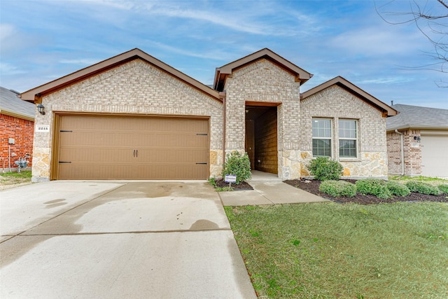 view of front of house with a garage, brick siding, driveway, and a front lawn