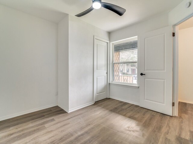 unfurnished bedroom with a ceiling fan, a closet, baseboards, and light wood finished floors