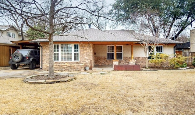 single story home with a carport, stone siding, and driveway