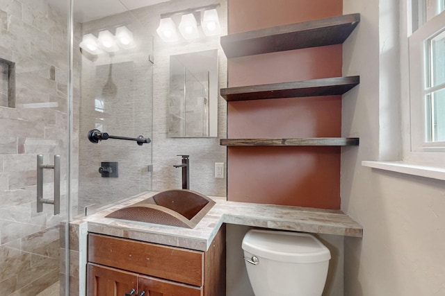 bathroom with toilet, a shower stall, decorative backsplash, and vanity