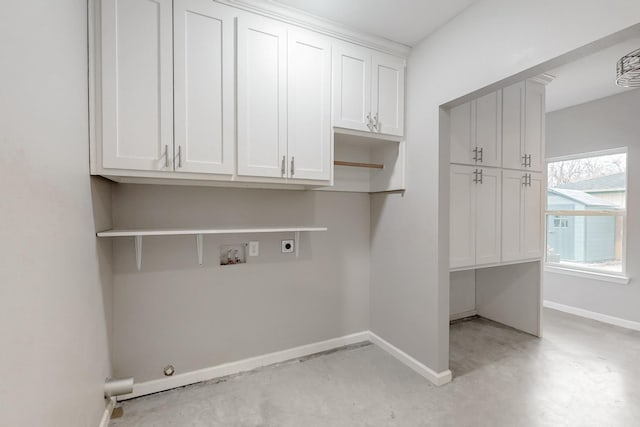 clothes washing area featuring cabinet space, baseboards, gas dryer hookup, hookup for an electric dryer, and washer hookup