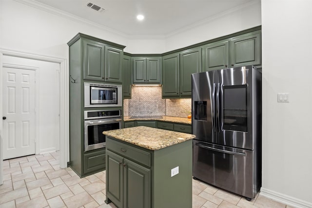 kitchen with stainless steel appliances, a center island, visible vents, green cabinets, and decorative backsplash