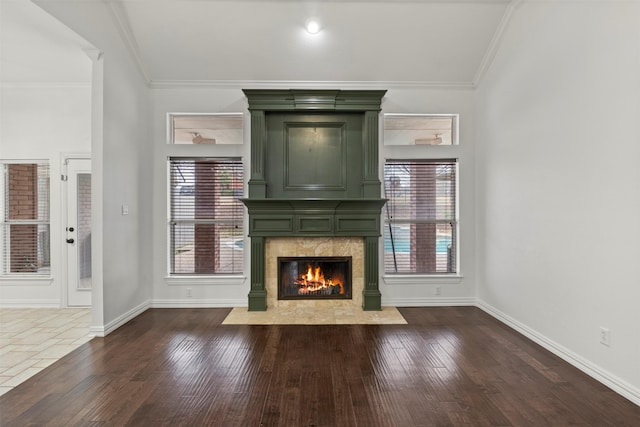 unfurnished living room featuring dark wood-style floors, a fireplace, and ornamental molding