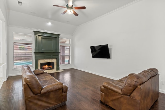 living room featuring dark wood-type flooring, lofted ceiling, visible vents, and a fireplace