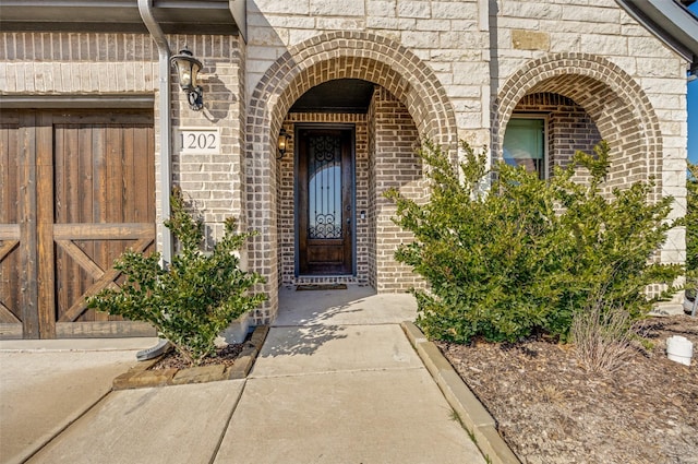 doorway to property with brick siding