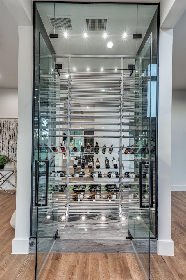 wine area featuring wood finished floors and visible vents