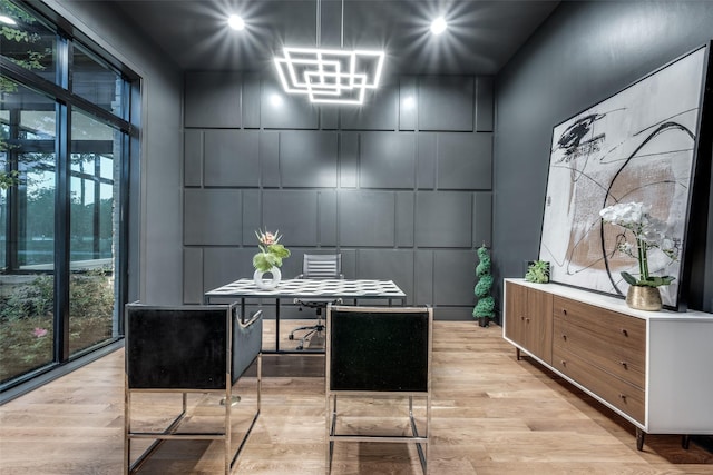 office space featuring light wood-style floors and a decorative wall